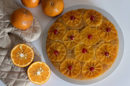 Orange upside down cake, also known as citrus caramel cake or caramelized orange cake. Variety of upside down cake with orange slices. Moist, flavorful dessert, perfect for baking enthusiasts.