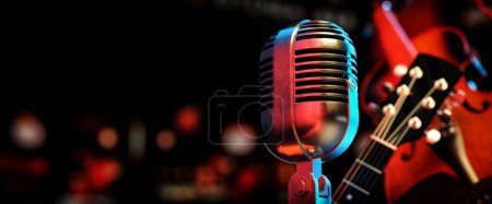 Photo for Close-up of a classic silver microphone and a guitar, violin instrument in a dark studio. 3D renderings and illustrations. - Royalty Free Image