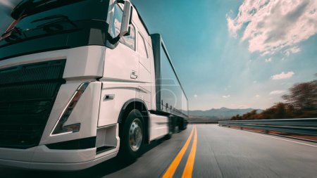 Photo for A large white truck is traveling on the highway in a left-to-right direction. The sky behind is bright blue.3d, rendering, illustration,- - Royalty Free Image