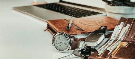 Photo for On the desk, an open laptop sits next to a wallet, pen clock, and car keys. 3d, rendering, illustration, - Royalty Free Image