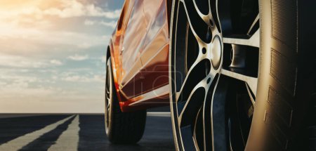Téléchargez les photos : Vue latérale rapprochée d'une voiture de sport de luxe orange sur la route au coucher du soleil.3d rendu et illustration. - en image libre de droit