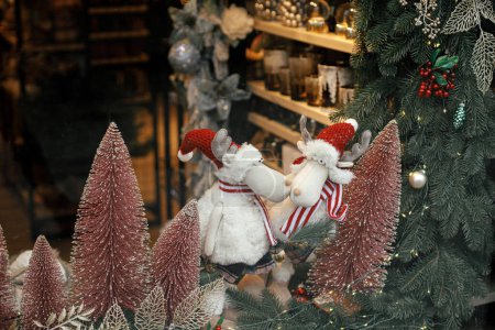 Téléchargez les photos : Élégants arbres roses de Noël, branches avec des boules et des rennes magasin de jouets, vitrine festive de la boutique. Décor de Noël moderne dans la rue de la ville. Vacances d'hiver en Europe. Joyeux Noël - en image libre de droit
