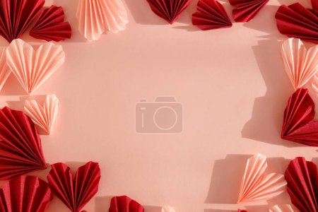 Photo for Happy Valentine's day! Stylish pink and red hearts flat lay on pink paper background. Modern cute valentine hearts cutouts in frame,  with space for text. Creative love background - Royalty Free Image