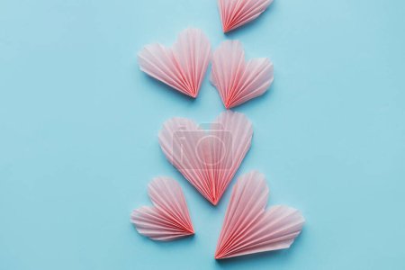 Photo for Happy Valentine's day! Stylish pink hearts on blue paper background flat lay. Modern cute valentine heart cutouts composition with space for text. Creative love banner - Royalty Free Image