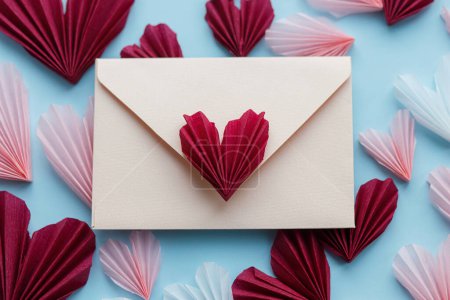 Photo for Happy Valentine's day. Valentines day flat lay. Stylish envelope with pink and red hearts composition on blue paper background. Creative modern valentine hearts cutouts. Love letter - Royalty Free Image