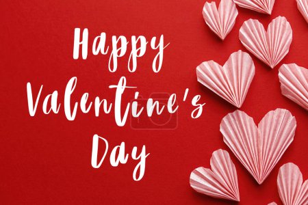 Téléchargez les photos : Happy valentines day text on cute pink hearts on red paper background flat lay. Modern Valentines day greeting card. Handwritten sign. Heart border - en image libre de droit