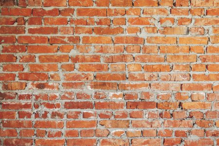 Foto de Bricks wall masonry close up with cement. Process of house building and building materials concept. Red bricks laying at construction site. Brick wallpaper pattern - Imagen libre de derechos