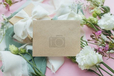 Photo for Stylish empty greeting card, gift and beautiful flowers on pink background flat lay. Happy women's day and mother's day concept. Tender spring image. Space for text - Royalty Free Image