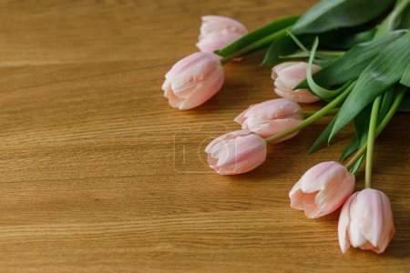 Photo for Beautiful tulips on wooden table with space for text. Modern easter decor. Stylish pink tulips bouquet. Happy mothers day and womens day - Royalty Free Image