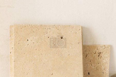 Photo for Travertine tiles against gypsum plaster wall. Construction of house and home renovation concept. Stylish natural travertine stone tile close up - Royalty Free Image
