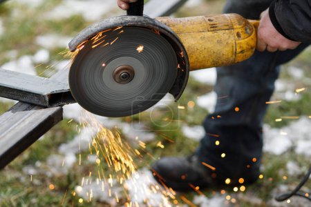 Photo for Close up of man grinding metal with circular grinder disc and electric sparks. Worker cutting metal with angle grinder for welding. Workers making fence with shielded metal arc welding - Royalty Free Image