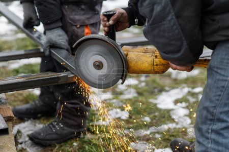 Photo for Worker cutting metal with angle grinder machine for welding iron. Close up of circular grinder disc and electric sparks. Workers making fence with shielded metal arc welding - Royalty Free Image