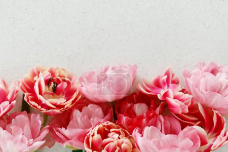Foto de Hermosos tulipanes planos sobre fondo de piedra gris, espacio para el texto. Elegante ramo floral. Feliz día de San Valentín y feliz día de la madre. Tierna rosa y rojo flores fondo de pantalla - Imagen libre de derechos