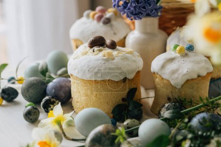 Photo for Happy Easter! Stylish easter eggs, homemade easter bread and spring flowers on linen napkin on rustic table. Natural painted marble eggs, blooms and holiday food. Modern still life - Royalty Free Image