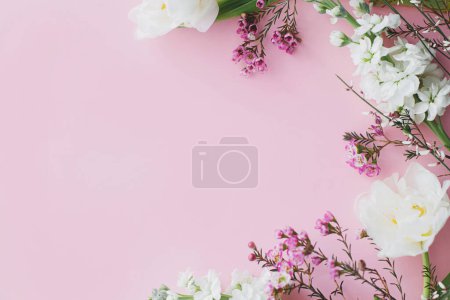 Photo for Happy Mothers day. Stylish flowers flat lay on pink background with space for text. White tender tulips and spring flowers border, greeting card template. Floral banner. Happy Womens day - Royalty Free Image