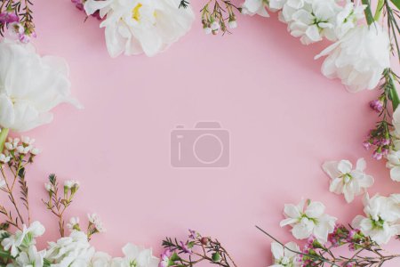 Téléchargez les photos : Fleurs élégantes plat posé sur fond rose avec de l'espace pour le texte. Joyeuse journée des femmes et fête des mères. Beau cadre de tulipes et fleurs printanières, modèle de carte de vœux. Bannière florale - en image libre de droit