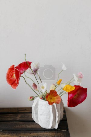 Photo for Flowers in modern vase rustic still life. Beautiful red and yellow poppies on aged wooden bench. Summer wildflowers, floral wallpaper. Space for text - Royalty Free Image