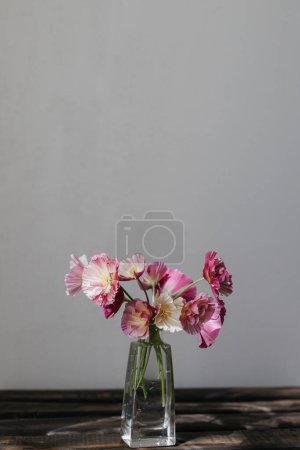 Photo for Stylish bouquet on rustic background. Beautiful pink california poppy in vase. Summer flowers, floral moody still life. Space for text - Royalty Free Image