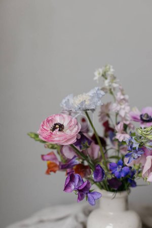 Photo for Stylish bouquet on rustic linen background. Beautiful colorful anemone, ranunculus, lathyrus scabiosa in vase. Summer flowers, floral moody still life. Space for text - Royalty Free Image
