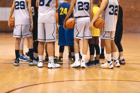 Photo for Youth Basketball Team Huddling Together United for Victory. Young Players in Basketball Team Gathering During Break Time. Junior Level Basketball Players - Royalty Free Image