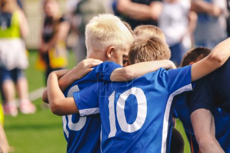 Photo for Children in Sports Team. Friends on a Soccer Team. Male Football Players Huddling Together in a Circle Before a Match - Royalty Free Image