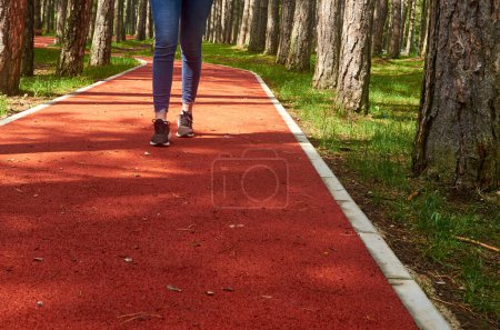 Photo for Red running rout with a girl running on it - Royalty Free Image