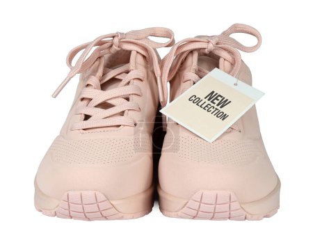 Photo for Women's sneakers with a sale tag or a price card isolated from background. I am the author of the text on the label New collection. Pink color. Front view - Royalty Free Image