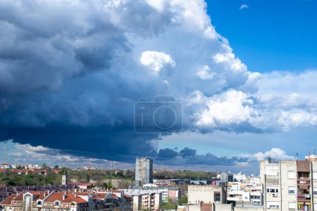 Photo for Dramatic stormy sky above a quarter of city residential buildings - Royalty Free Image