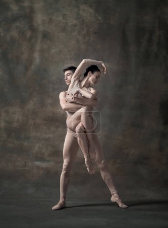 Photo for Young man and woman, ballet dancers performing isolated over dark green vintage background. Tender support. Contemporary ballet. Concept of classic dance, artist, beauty. Copy space for ad - Royalty Free Image