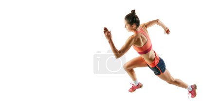Photo for One sportive girl in sports uniform isolated over white background. Concept of sport, beauty, action, achievements, hobbies. Young athlete, runner looks motivated and concentrated - Royalty Free Image