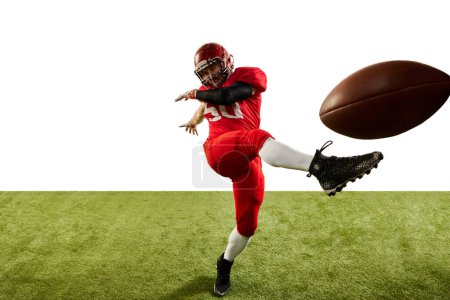 Photo for Professional american football player in sports uniform and protective helmet in action isolated over white background. Concept of active life, team game, energy, sport, competition. Copy space for ad - Royalty Free Image