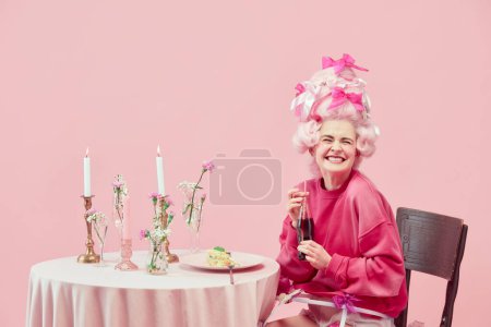 Photo for Portrait with funny, happy princess, queen wearing elegant clothes and wig drinking cola and smiling over pink background. Concept of comparison of eras, modernity and renaissance, beauty, history - Royalty Free Image