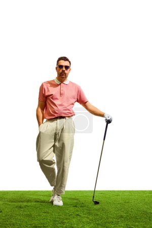 Photo for Full length portrait of confident professional golfer player stands on green grass at golf club in summer time. Golfers focus, unwavering and determined. Concept of game, sport, recreation. - Royalty Free Image