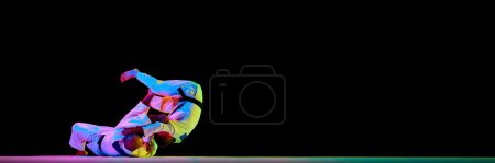 Photo for Banner. Two men Judoist training, fighting showing technical skill in neon light isolated black studio background. Concept of martial art, combat sport, health, strength, energy, fit. Copy space - Royalty Free Image