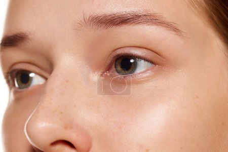 Close up shot of of with beautiful female eyes without makeup and with well-kept skin. Anti-aging treatment, rejuvenation. Concept youth, beauty, healthy lifestyle, anti aged cosmetic products. Ad