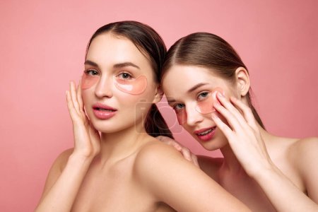 Photo for Refreshed radiance. Young girls emphasize their natural beauty sans makeup, embracing art of self-care with moisturized, hyaluronic under-eye patches Concept of beauty treatments, anti-aging, spa. Ad - Royalty Free Image