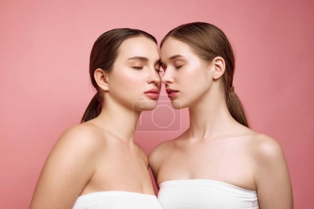 Photo for Collective radiance. Girls flourish in natural unity. Couple portrait of young women with bare shoulders posing against pastel background. Concept of female health, cosmetic products, make-up. Ad - Royalty Free Image