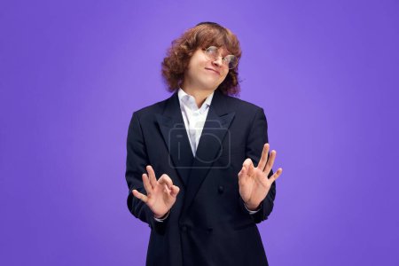 Photo for Portrait f charismatic man looks at camera and expressed that everything will be fine looking at camera and gesturing Ok sign. Purim, festival, holiday, celebration Pesach or Passover concept. Ad - Royalty Free Image