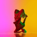 Creative, dynamic photo of breakdance performing freezes in neon light against gradient pink-yellow background. Concept of art, hobby, sport, creativity, fashion and style, action. Ad