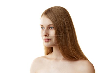 Photo for Portrait of young beautiful woman 20 years old with long silky hair looking away against white studio background. Concept of natural beauty, organic cosmetic, spa procedures, face-care. - Royalty Free Image