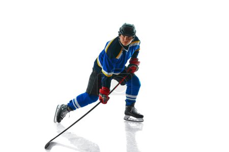Photo for Focused professional hockey player with stick showing of puck control against white studio background. Concept of professional sport, competition, movement, tournament, match, healthy lifestyle. Ad - Royalty Free Image