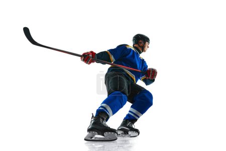 Photo for Hockey player undergoes rigorous training, his uniform symbol of dedication as he perfect his techniques against white studio background. Concept of sport, competition, energy, tournament, match. Ad - Royalty Free Image