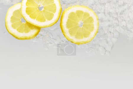 Close up photo through transparent glass of refreshing, detoxing drink with lemon and ice. Textured photo. Abstract wallpaper. Concept of food and drinks, summer,vitamins, nutrition.