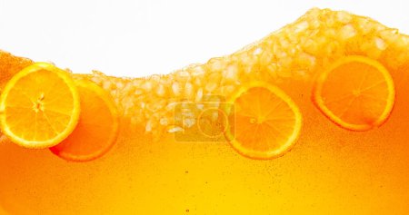 Close up shot of orange slices in refreshing summer drink. Tropical paradise. Textured photo. Abstract wallpaper. Concept of food and drinks, summer,vitamins, nutrition, dieting. Ad
