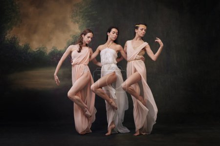 Group portrait of beautiful women in flowing dresses dancing synchronously against vintage studio background. Concept of ballet, history and classic, fusion of modernity and ancient times in art.