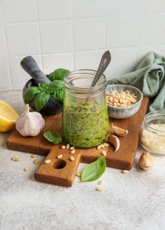 Photo for Fresh made Pesto sauce. Green basil pesto.  Ingredient for pesto sauce - Fresh Basil, Pine Nuts, Olive Oil and Cheese - Royalty Free Image
