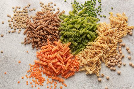 Photo for A variety of fusilli pasta made from different types of legumes, green and red lentils, mung beans and chickpeas. Gluten-free pasta. - Royalty Free Image