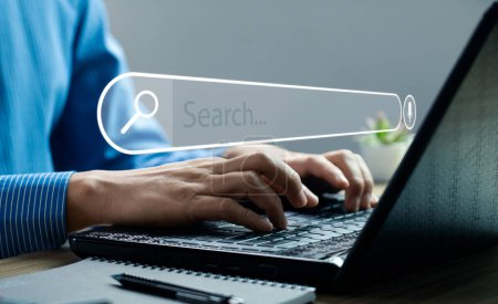 Businessman hand using laptop or computer to search information on internet social media web with search box icon and copy space. search engine information search technology