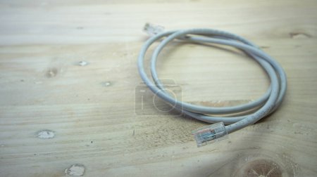 Foto de Lan utp cable is gray with a wooden background - Imagen libre de derechos