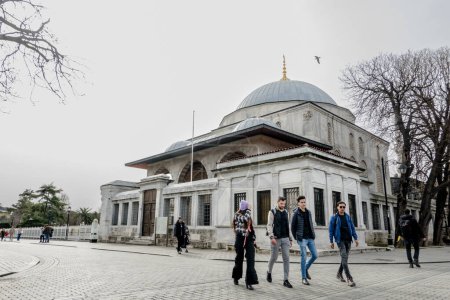 Foto de Los turistas caminan por la famosa Mezquita Azul en la zona de Sultanahmet de Estambul. La Mezquita Azul es una mezquita imperial histórica de la época otomana. Fue construido entre 1609 y 1616 durante el gobierno de Ahmed I.. - Imagen libre de derechos